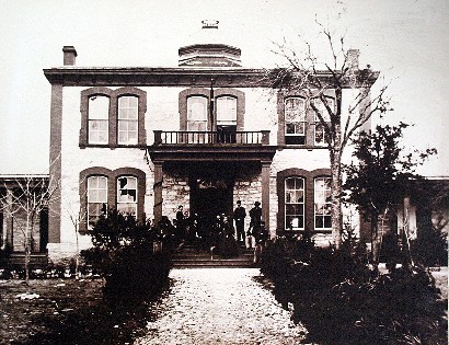 General George A. Custer, staff and wives, pose on the steps of the Blind Asylum in the winter of 1865