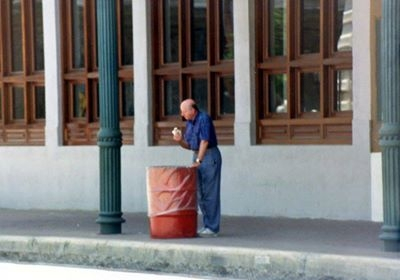 George Mitchell leaning over the trash can 
