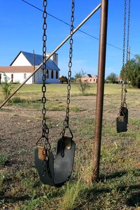 Old Swings on an abandoned schoolyard