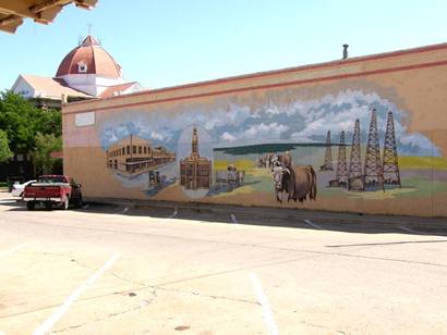 Henrietta Tx painted wall mural showing courthouse, cattle and oil derricks