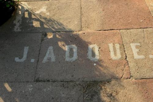 Adoue Building name on sidewalk, Calvert Texas