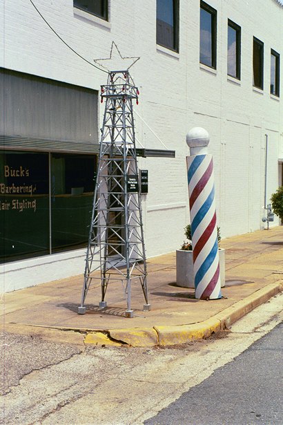 Barber pole and miniature oil derrick in Kilgore