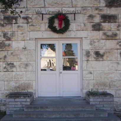 Val Verde County Jail with reflection of church, Del Rio, Texas