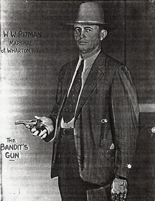 Marshal Pitman with the bandit's gun