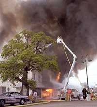 La Grange's Muster Oak and firemen fighting fire  