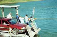 men pulling ferry Los Ebanos Texas