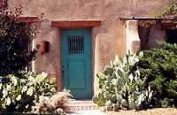 adobe home with cactus