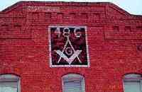 Masonic emblem painted on brick wall