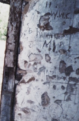 Frio TownT X - 1872 Old Frio County Jail inerior wall with prisoner's marking