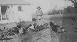 Martina Mendez Ramirez feeding her chickens, July 7, 1925 