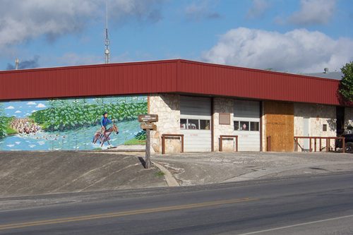 'Crossing the Medina' mural on Bandera City Office Building on Main Street 