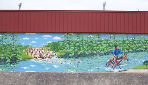 Bandera, TX 'Crossing the Medina' mural on Bandera City Office Building on Main Street 