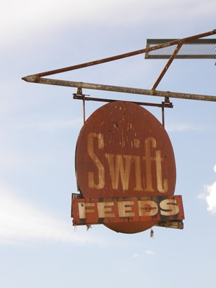 Old rusted Swift FEEDS sign in Comfort, Texas