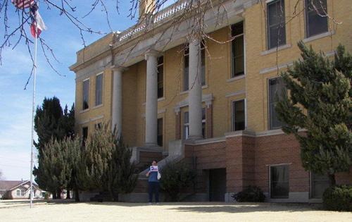 Terry Jeanson in front of the last of the 254 courthouses - Roberts County Courthouse, Miami,  TX