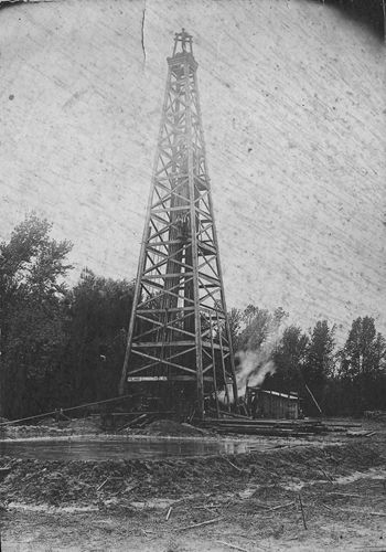 Lodi, Texas oil derrick with  pool of crude oil