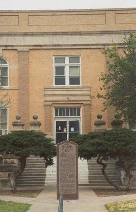 1910 Foard County Courthouse entrance and granite monument, Crowell, Texas