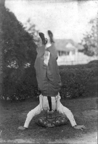 Man standing on head in celebration of birthday